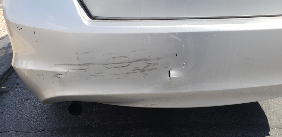 Picture1 image of a grey car with a punctured bumper.